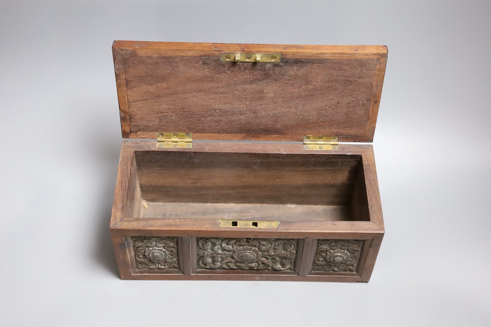 A carved wood panelled box, stamped The Madras School of Art, with label dated 1897, 29cm